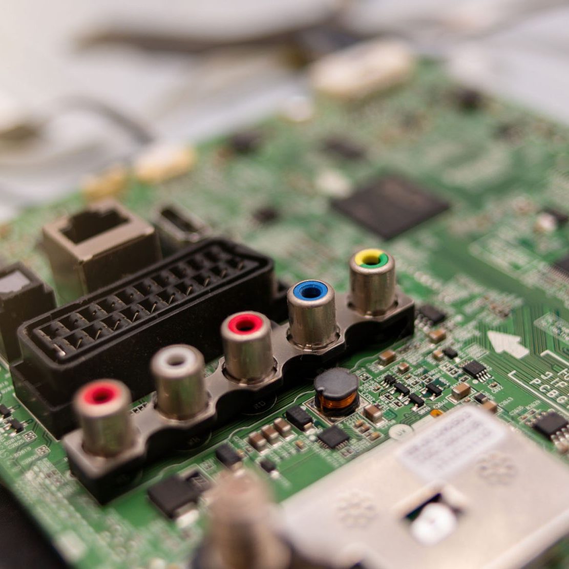 dreamstime_m_291522138 TV repair in the service center, engineer soldering electronic components on board